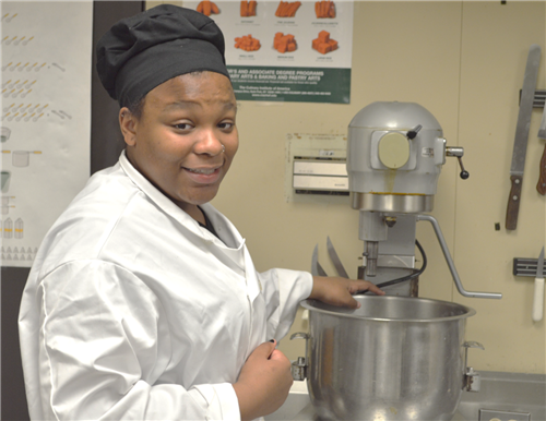 Culinary Arts student using the industrial mixer 